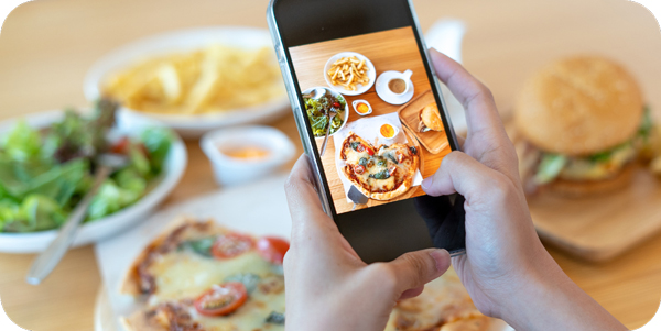 A person taking a picture of food on their phone