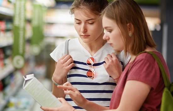 Two people reading nutrition labels at the store
