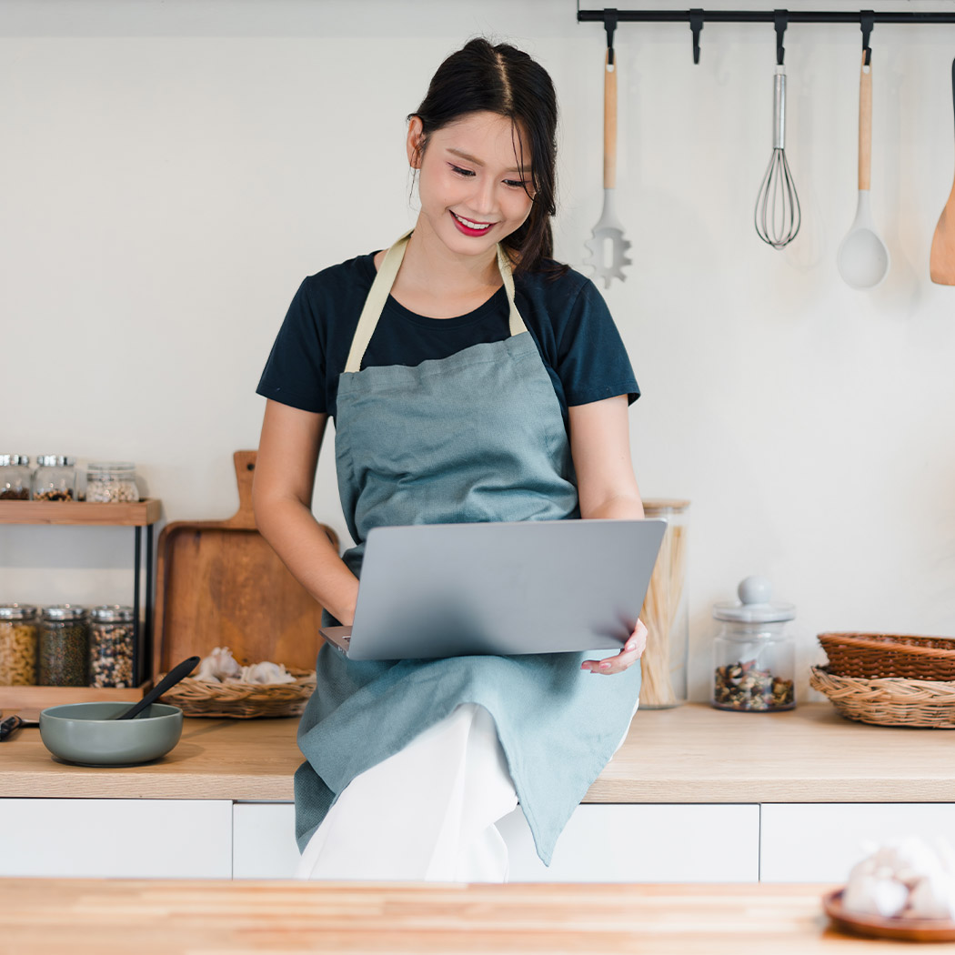 Community_Woman_Kitchen_Laptop